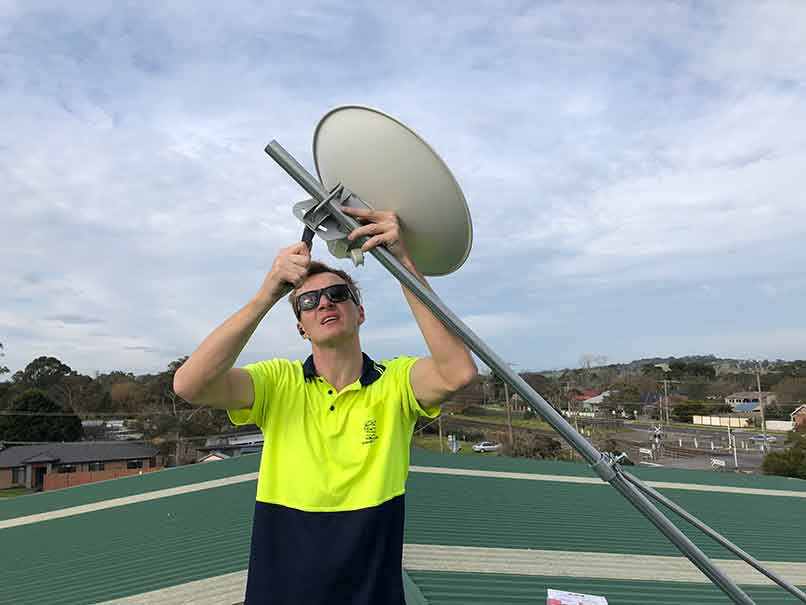 Installing summit's fixed wireless on the roof of St Thomas Aquinas College